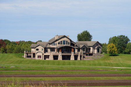 Photo for Tomah, Wisconsin USA - October 1st, 2022: Extraordinary luxury stone mansion sits on countryside. - Royalty Free Image