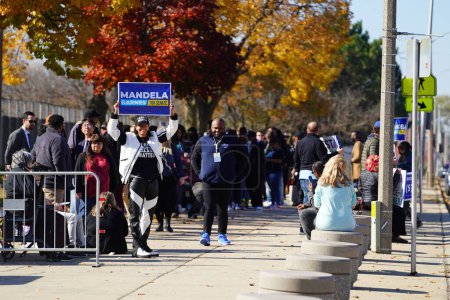 Photo for Milwaukee, Wisconsin USA - October 29th, 2022: Many Democrat voters lined up at North Division High school to participate at Governor Tony Evers, Mandela Barnes and Barack Obama Democratic party rally - Royalty Free Image