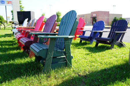 Photo for Colorful wooden lawn chairs set up outside to be sold in the fond du lac, wisconsin area. - Royalty Free Image