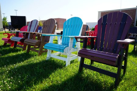Photo for Colorful wooden lawn chairs set up outside to be sold in the fond du lac, wisconsin area. - Royalty Free Image