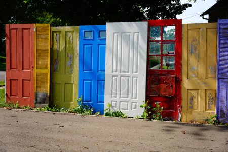 Photo for Group of random colorful doors being used as a yard fence in columbus, wisconsin. - Royalty Free Image