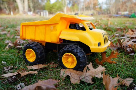 Photo for Yellow toy dump truck sits outside - Royalty Free Image