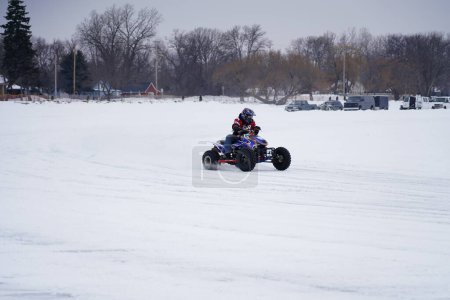 Photo for Hortonville, Wisconsin / USA - January 26th, 2019: Many riders on Quad-bikes and ATVs were having fun riding around on snow covered frozen iced lake - Royalty Free Image