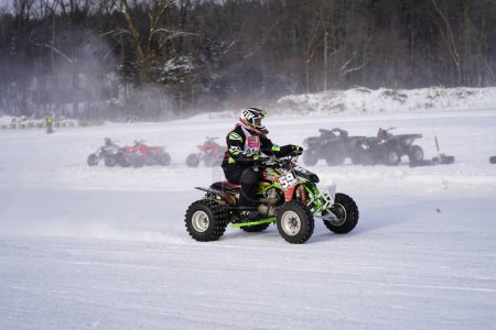 Photo for Hortonville, Wisconsin / USA - January 26th, 2019: Many riders on Quad-bikes and ATVs were having fun riding around on a snow-covered frozen iced lake. - Royalty Free Image