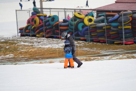 Photo for Kewaskum, Wisconsin / USA - December 24th, 2019: Community members came out to enjoy themselves snowboarding on the day before Christmas at Sunburst Winter Sports Park for Santa Slalom event. - Royalty Free Image