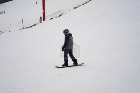 Photo for Kewaskum, Wisconsin / USA - December 24th, 2019: Community members came out to enjoy themselves snowboarding on the day before Christmas at Sunburst Winter Sports Park for Santa Slalom event. - Royalty Free Image
