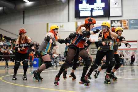 Photo for Oshkosh, Wisconsin USA  - October 12th, 2020: Adult females play in physical contact Roller Derby teams and compete against each other at Oshkosh Arena. - Royalty Free Image