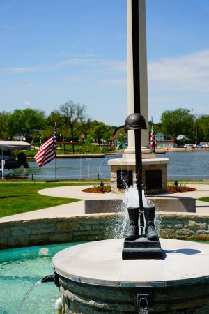 Photo for Oconomowoc, Wisconsin / USA - May 25th, 2020: Oconomowoc veteran memorial site sits between lake fowler and lac la belle giving honor and remembrance to all the brave men and women that have fought. - Royalty Free Image