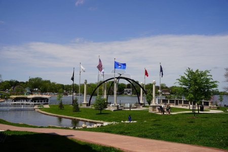 Photo for Oconomowoc, Wisconsin / USA - May 25th, 2020: Oconomowoc veteran memorial site sits between lake fowler and lac la belle giving honor and remembrance to all the brave men and women that have fought. - Royalty Free Image