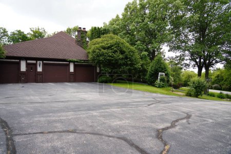 Photo for Fond du Lac, Wisconsin / USA - June 6th, 2019: Outside side view of a 3 vehicle garage of a 1970s house outside of Fond du Lac, Wisconsin - Royalty Free Image