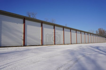 Photo for Extra large tall red and white storage units used for the community sit outside during the winter cold. - Royalty Free Image