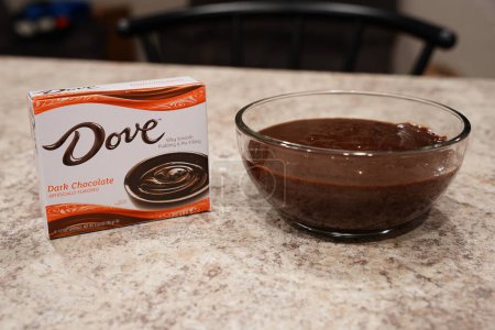 Photo for Fond du Lac, Wisconsin USA - February 15th, 2024: A box of Dove Dark Chocolate pudding mix sits next to a bowl of Chocolate pudding. - Royalty Free Image