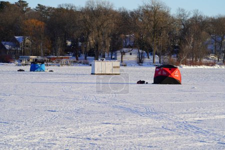 Photo for Green Lake, Wisconsin USA - January 20, 2024: People ice fishing out on a frozen lake in ice shanties. - Royalty Free Image