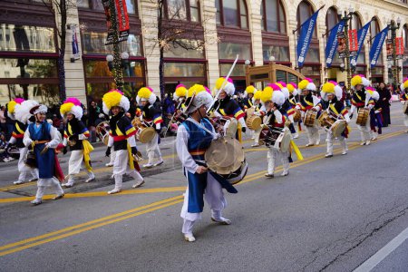 Photo for Chicago, Illinois USA - November 23rd, 2023: Members of Korean Performing arts institute of Chicago marching band marched through State Street during Thanksgiving Day Parade. - Royalty Free Image
