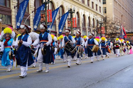 Photo for Chicago, Illinois USA - November 23rd, 2023: Members of Korean Performing arts institute of Chicago marching band marched through State Street during Thanksgiving Day Parade. - Royalty Free Image