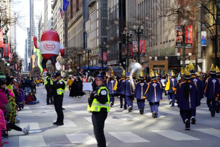 Photo for Chicago, Illinois USA - November 23rd, 2023: Members of the Chicago Thanksgiving Day Parade pulled the Grinch character balloon through State Street. - Royalty Free Image
