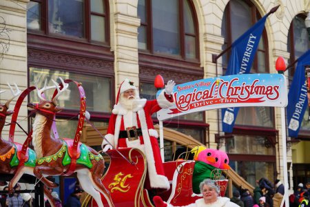 Photo for Chicago, Illinois USA - November 23th, 2023: Elder Gentlemen dressed up in a Santa Claus Suit Costume waving at the spectators at 2023 Chicago Thanksgiving Parade. - Royalty Free Image