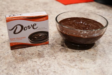 Téléchargez les photos : Fond du Lac, Wisconsin États-Unis - 15 février 2024 : Une boîte de pudding au chocolat noir Dove se trouve à côté d'un bol de pudding au chocolat. - en image libre de droit