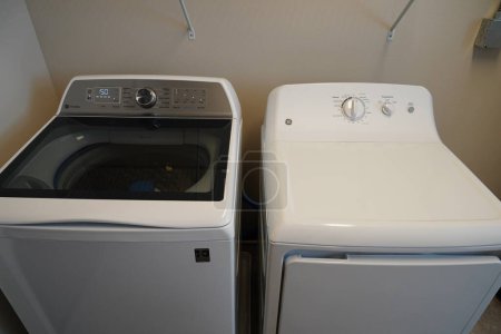Photo for Fond du Lac, Wisconsin USA - February 1st, 2023: GE washing machine and GE clothes dryer sits in the laundry room. - Royalty Free Image