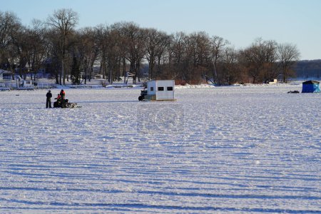 Photo for Green Lake, Wisconsin USA - January 20, 2024: People ice fishing out on a frozen lake in ice shanties. - Royalty Free Image
