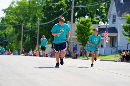 Photo for Little Chute, Wisconsin USA - June 5th, 2021: Family members and kids ran and walked in the Great Wisconsin Cheese festival mile run. - Royalty Free Image