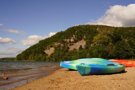 Photo for Baraboo, Wisconsin USA - September 21st, 2021: Colorful kayaks sit on sandy beach at Devil's Lake state park. - Royalty Free Image