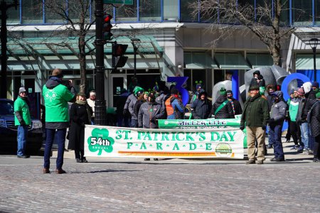 Photo for Milwaukee, Wisconsin USA - March 12th, 2022: Members from Shamrock club dressed up for St. Patrick's day and held banners for the parade. - Royalty Free Image