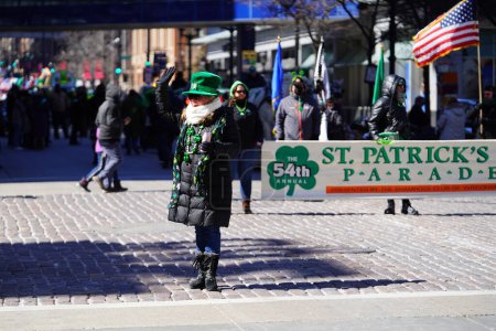 Photo for Milwaukee, Wisconsin USA - March 12th, 2022: Members from Shamrock club dressed up for St. Patrick's day and held banners for the parade. - Royalty Free Image