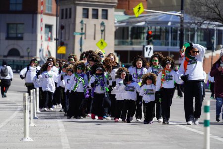 Photo for Milwaukee, Wisconsin USA - March 12th, 2022: Kids and adults from Glencastle Irish Dance group danced in St. Patrick's Day parade. - Royalty Free Image