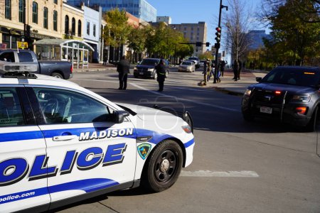 Foto de Madison, Wisconsin / Estados Unidos - 7 de noviembre de 2020: Los agentes de policía de Madison dirigen el tráfico en las calles durante la protesta por la vida de los negros y triunfan en el mitin de apoyo. - Imagen libre de derechos