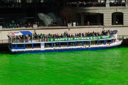Photo for Chicago, Illinois USA - March 16th, 2024: Spectators took boat tours on the Chicago River during the water dyeing. - Royalty Free Image