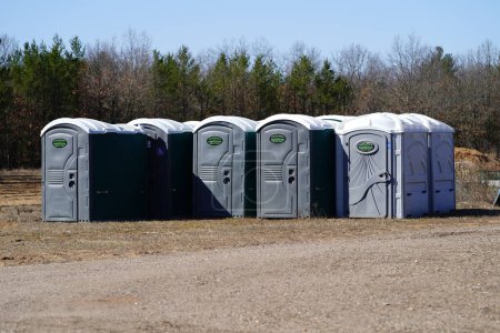 Photo for New Lisbon, Wisconsin USA - March 29th, 2024: Group of porta potties gathered together sitting outside waiting to be used. - Royalty Free Image