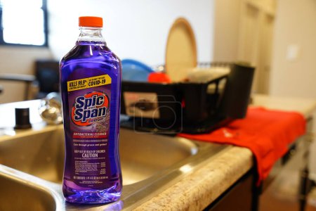 Foto de Fond du Lac, Wisconsin, EE. UU. - 6 de abril de 2024: Una botella púrpura de Lavanda COVID que mata a un limpiador antibacteriano se sienta en un mostrador en una cocina. - Imagen libre de derechos
