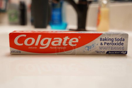 Photo for Fond du Lac, Wisconsin USA - April 21st, 2024: A box of a tube of Colgate Baking Soda and Peroxide Whitening Toothpaste sitting in the bathroom. - Royalty Free Image
