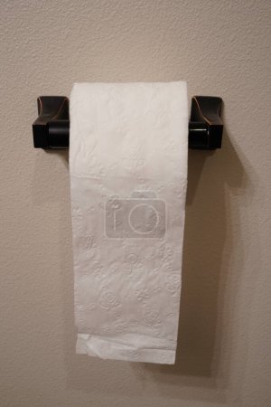 Photo for Toilet paper roll on a bathroom dispenser holder. - Royalty Free Image