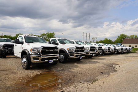 Foto de Burlington, Wisconsin USA - May 4th, 2024: A large collection of White Dodge Ram Trucks sit at a parking lot ready to be sold. - Imagen libre de derechos