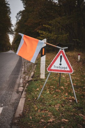 Photo for On the side of the road there is a sign with a flag with the warning Attention Drift Hunting - Royalty Free Image