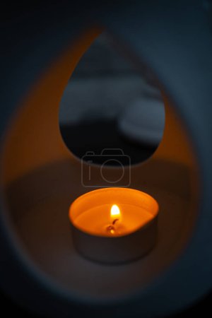 Photo for A small tea light burns in a fragrance lamp - Royalty Free Image