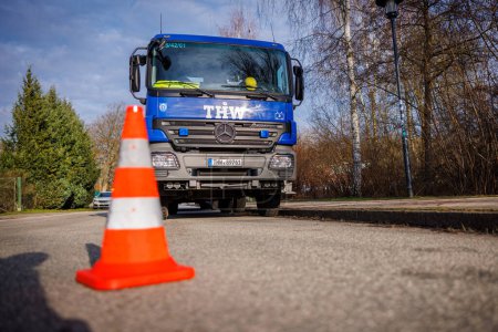 Photo for In front of the blue vehicle of the technical relief organization THW is an orange pylon - Royalty Free Image