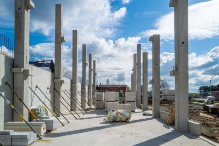 many concrete pillars for a factory building are erected on a construction site
