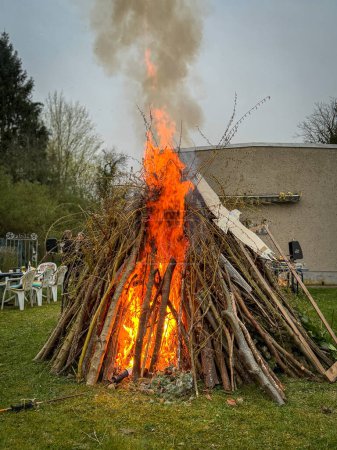 an Easter fire burns in the meadow