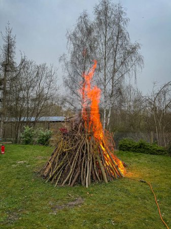 an Easter fire burns in the meadow