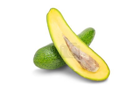 Half of fresh avocado isolated on white background. Ripe fresh green avocado with Clipping Path. collection Avocado studio macro shooting. Whole and half avocado, close-up. Exotic fruit as diet food