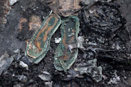 old burnt shoes in ashes. 