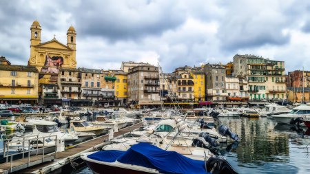 Corsica, France - 3 November 2022: Traditional fishing boats in Bastia port on sunny summer day, Corsica island, France