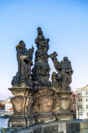 Statue of Madonna, St. Dominic and St. Thomas Aquinas on Charles Bridge in Prague, Czech Republic