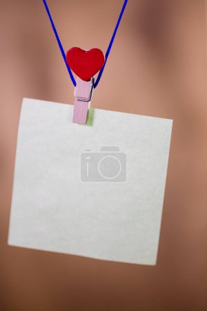 Photo for Heart clothes peg holding note with blank copy space - Royalty Free Image