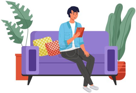Male sitting on couch at home, chatting, communicating using tablet electronic device. Man talking by phone on sofa. Male sits with smartphone. Distance learning, freelance and internet entertainment