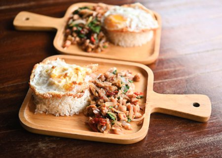 Photo for Stir-fried pork with basil, fried egg rice, Thai food, Thai food, the food on the wooden plate looks good and tastes good. - Royalty Free Image