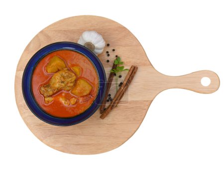 Photo for Chicken Curry or Masala Traditional Curry with turmeric spices and arranged black on a wood plate ; top view. - Royalty Free Image